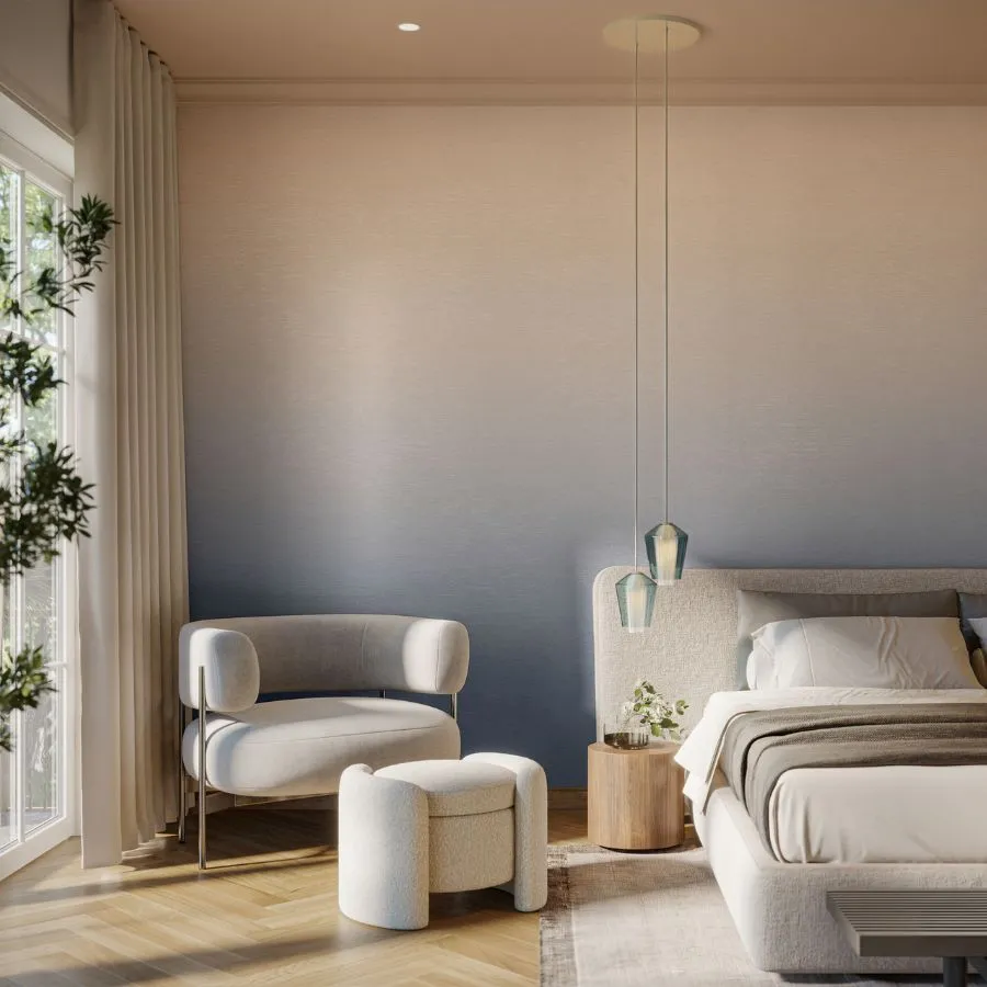 Elysian unfolds in a graceful sweep of ombre color that moves effortlessly across the wall, digitally printed on a natural woven cellulose laced with gold metallic foil. The soft gradient evokes the shifting beauty of the sky throughout the day, from the quiet glow of dawn to the deep stillness of night. Each hue blends seamlessly into the next, offering depth and radiance that transform interiors with a sense of calm sophistication.