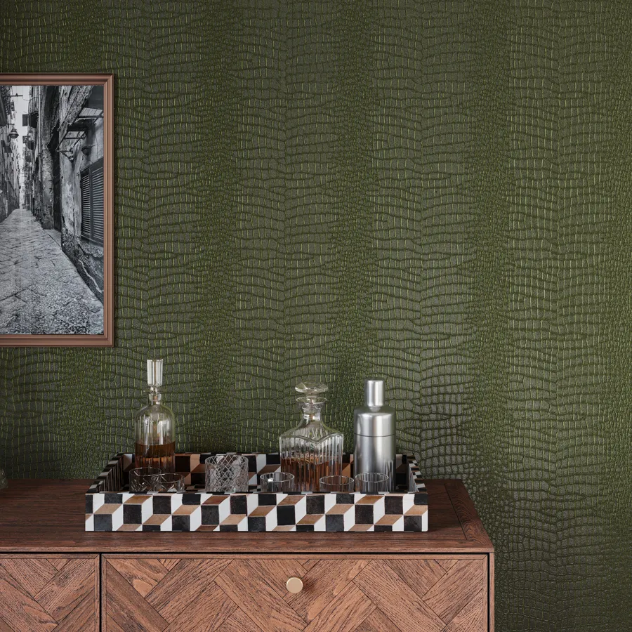 Naples interprets the timeless allure of crocodile leather into a versatile type II vinyl wallcovering. A rich base color in opulent hues of green, blue, burgundy, or alongside strong neutrals is embossed with a crocodile motif and finished with a subtle matte sheen, delivering the soft touch and luxurious look of genuine leather with the added resilience and effortless maintenance of vinyl.