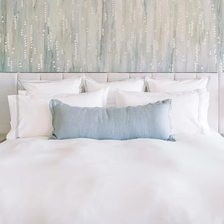 "It all started with the wallpaper for me," says Shaolin Low of the primary bedroom’s textured wallpaper by Innovations . "I found the sample, and I had to have it in my life. Thankfully, the clients felt the same. We pulled the entire bedroom together based on that wallpaper."